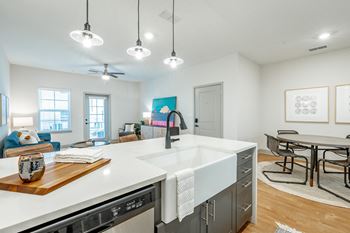 luxe amenity package with farmhouse sink, gooseneck faucet, and pendant lighting cottage open floor plan with luxe amenity package at Anthem Apartments and Cottages in Huntsville, Alabama